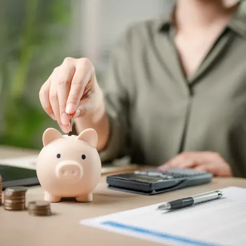 adding money to piggy bank